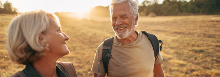 Chiropractic-Burbank-CA-Older-Couple-Smiling-at-Each-Other-While-Outside-on-a-Hike.jpg low back pain relief with chiropractic care